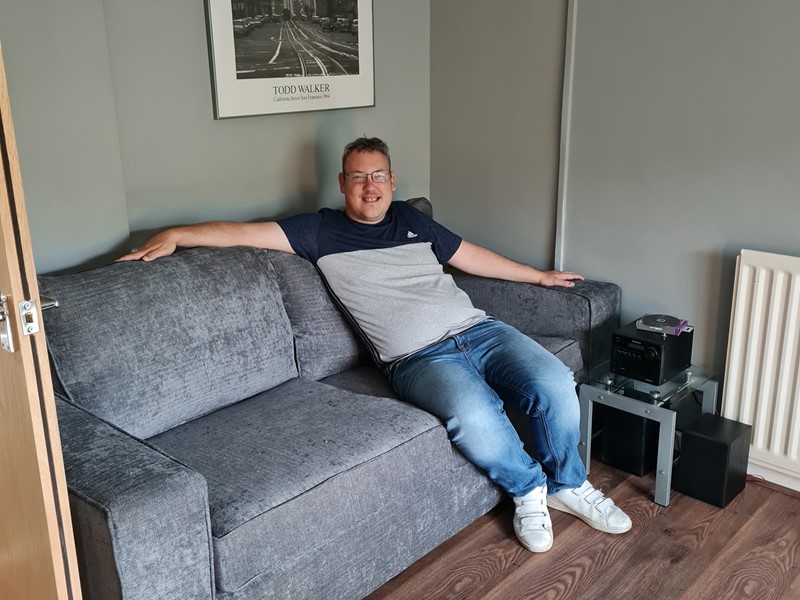 Denis relaxing in his living room